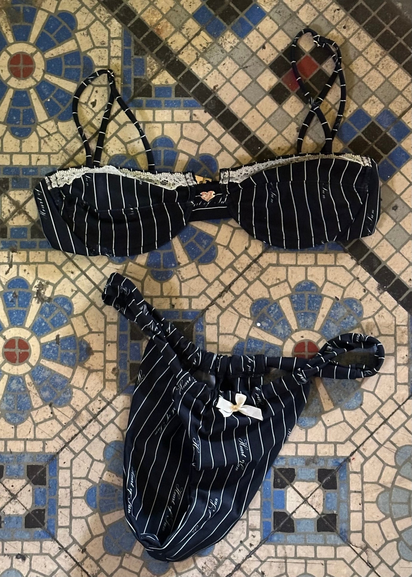 Pinstripe bikini with white lace detailing.