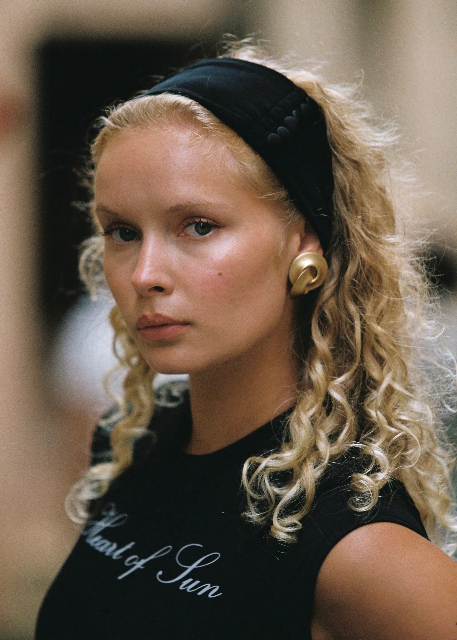 Model wearing the Penelope Headband in Ivory, featuring a classic, sleek satin design ideal for summer outfits.
