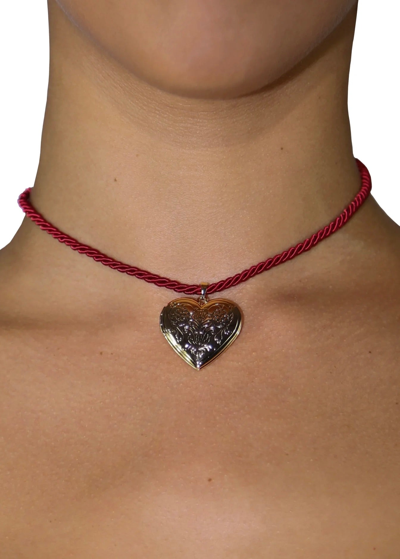 Model wearing the Heart Of Gold Necklace, a vintage-inspired red rope choker with a gold heart charm
