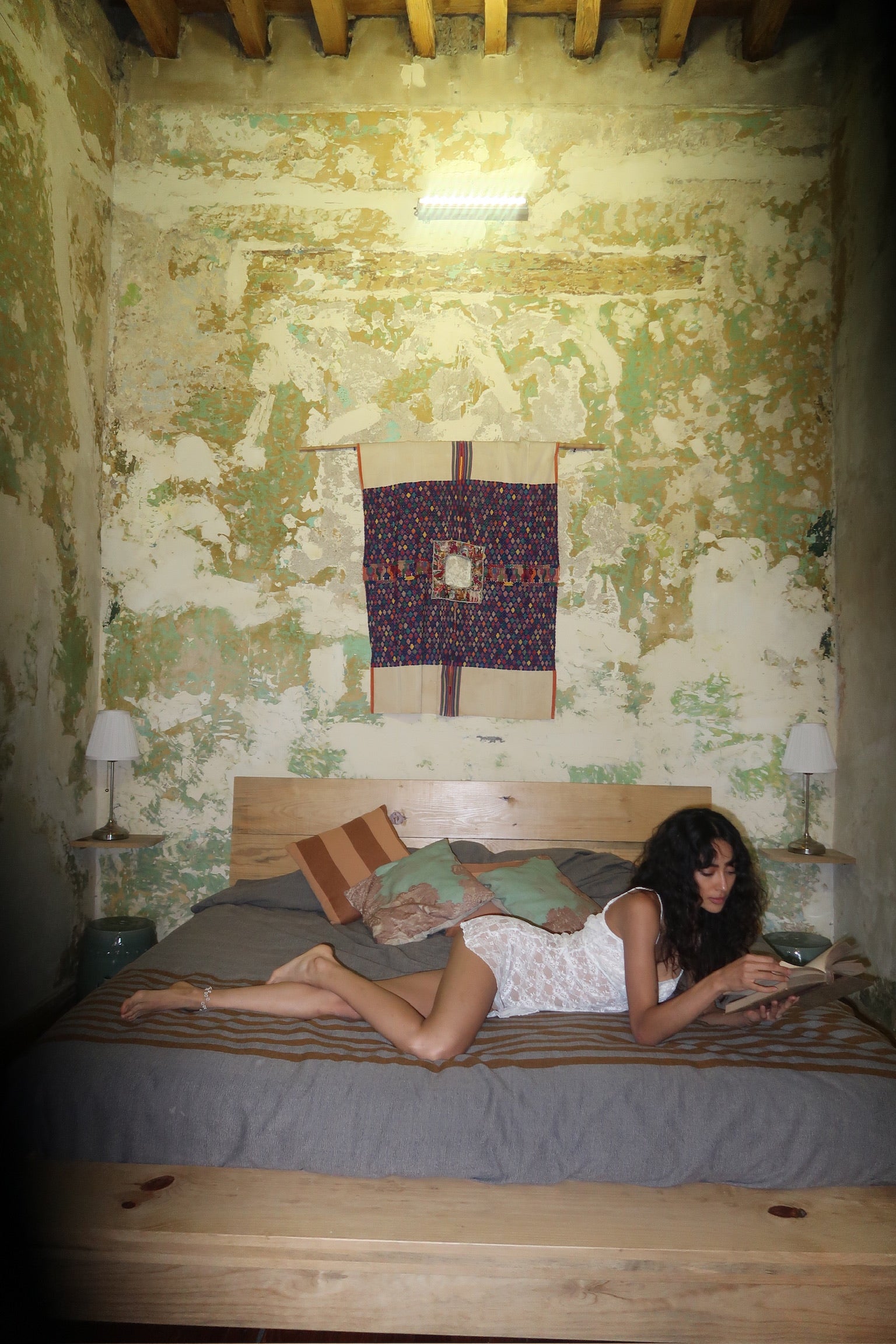 Model wearing Bisou Dress in Ivory, featuring delicate lace fabric, ruched cups, and a 90s babydoll silhouette.