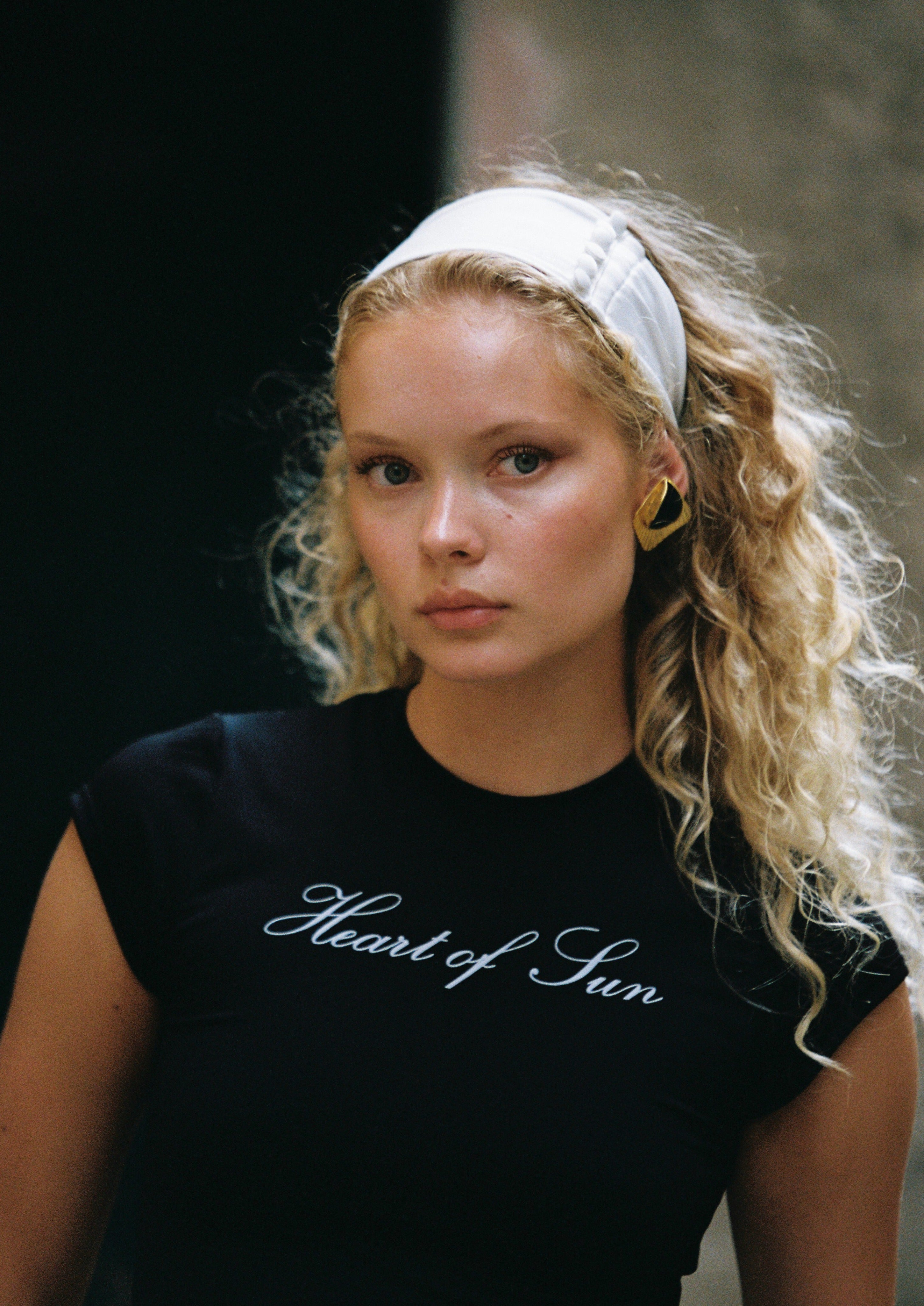 Model wearing the Penelope Headband in Ivory, featuring a thick, elegant design for standout style