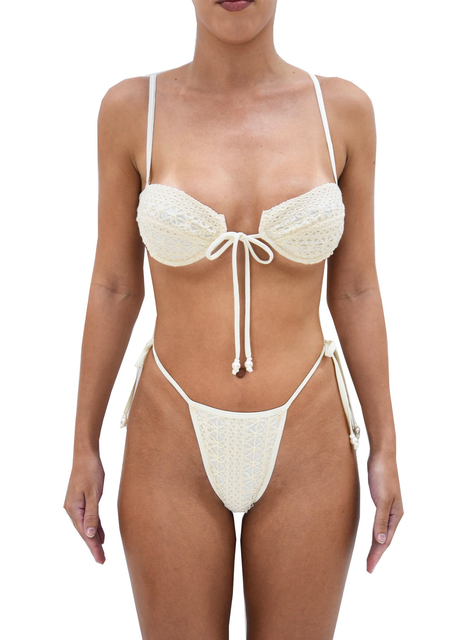Model wearing beige crochet bikini featuring its bottoms double tie side closure and high waisted fit.
