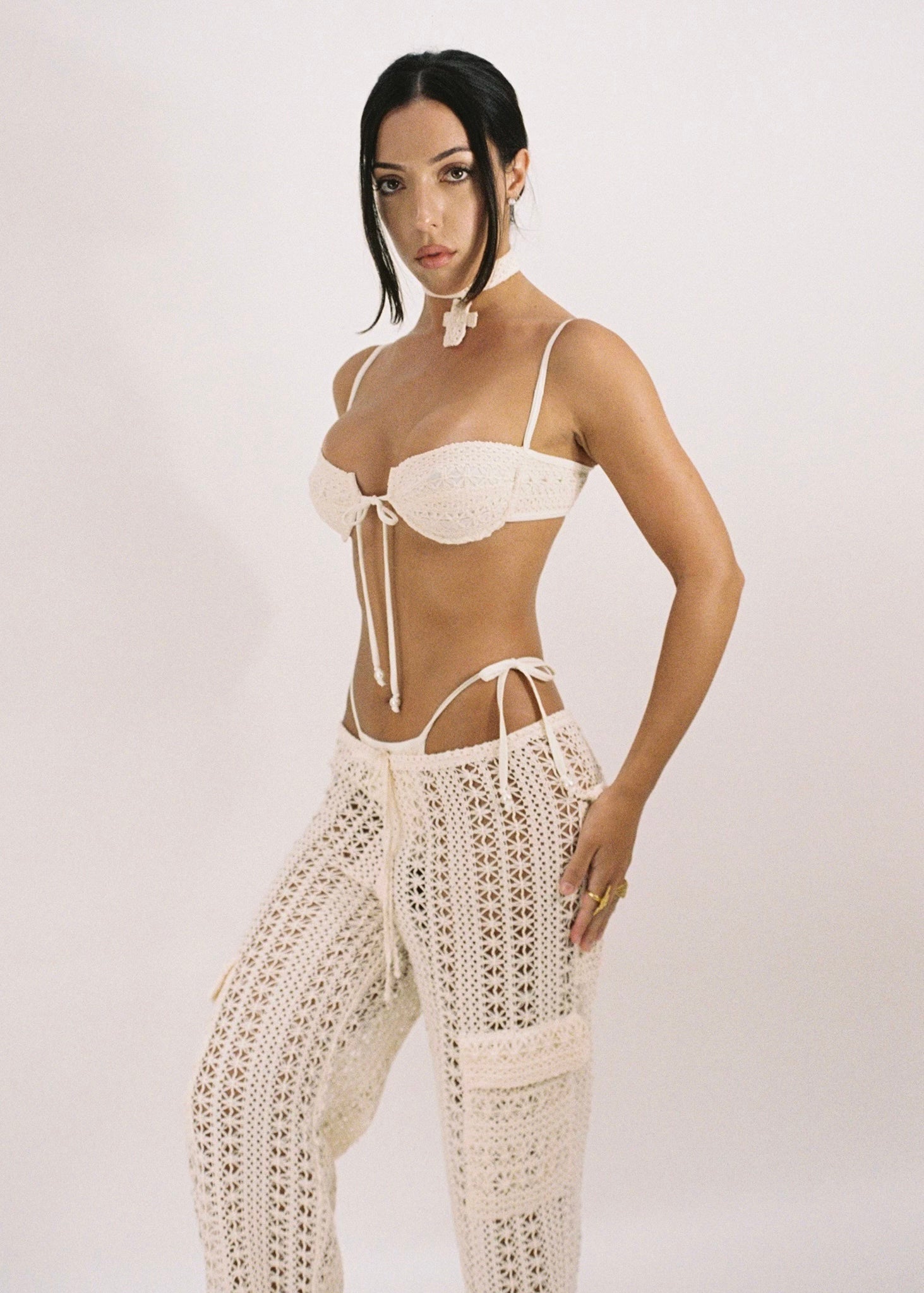 Model wearing beige crochet cargo pants paired with a beige crochet bikini.