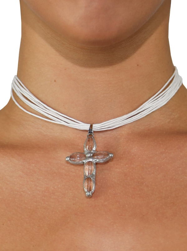 The Aurora Necklace with a white multi-rope cord and a clear cross pendant for a chic summer outfit or vintage-inspired look