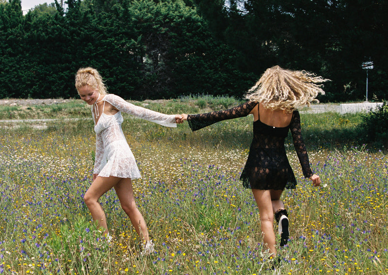 Models outdoors in the Bisou boleros in Ivory and Black a timeless lace touch, adding a chic vintage-inspired touch to any outfit