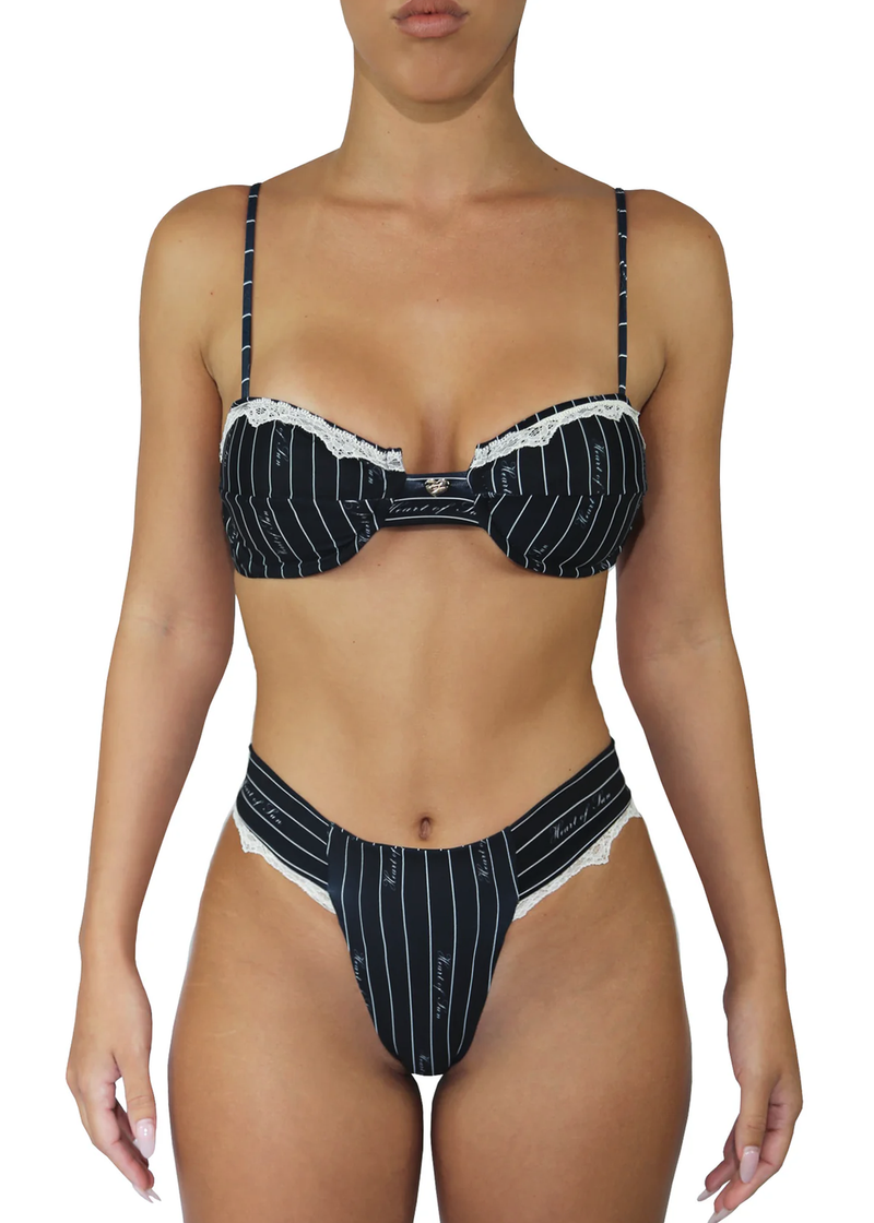 Close up of pinstripe underwire bikini top with lace detailing and matching bottoms. 